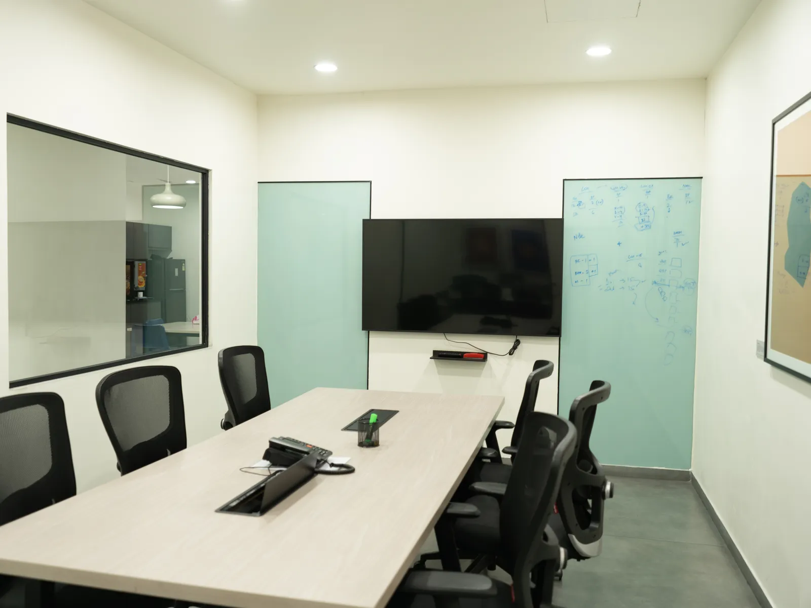 Conference room with TV screen and glass writing boards — LICO